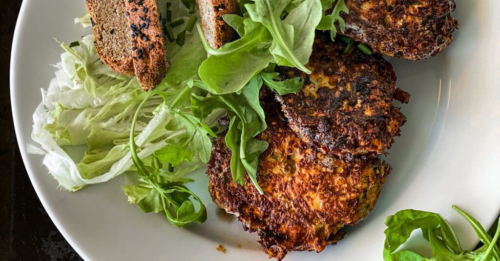 Crispy falafel with fresh lettuce and bread on a plate for a healthy meal.