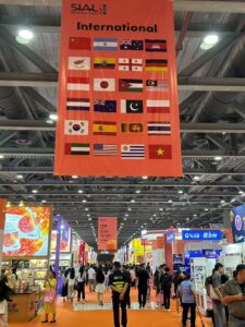 The International pavilion banner at SIAL Guangzhou 2026 — origins from Georgia and Jordan to Ecuador and Uruguay alongside the region's established ASEAN delegations.