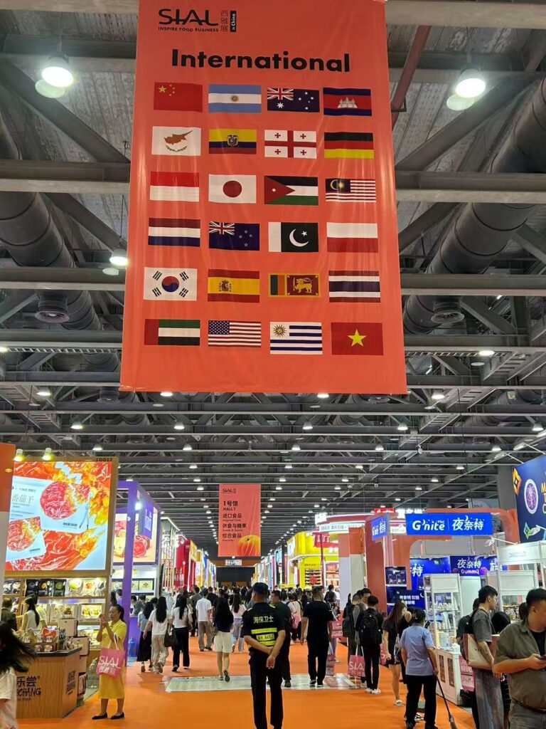 The International pavilion banner at SIAL Guangzhou 2026 — origins from Georgia and Jordan to Ecuador and Uruguay alongside the region's established ASEAN delegations.